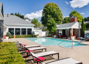 Thumbnail 3 of 28 - a swimming pool with lounge chairs next to a resort style pool at Residences at Stevens Pond, Massachusetts
