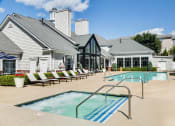 Thumbnail 1 of 28 - Soothing blue swimming pool with white lounge chairs at Residences at Stevens Pond, Saugus