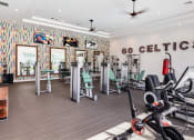 Thumbnail 10 of 28 - a gym with treadmills and other exercise equipment at Residences at Stevens Pond, Saugus