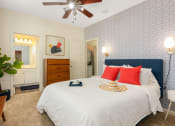 Thumbnail 13 of 28 - a bedroom with a large bed and a ceiling fan at Residences at Stevens Pond, Saugus, MA