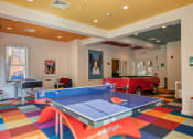 Thumbnail 7 of 28 - a game room with a ping pong table and a red truck at Residences at Stevens Pond, Saugus, 01906