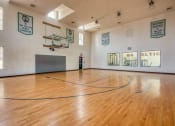 Thumbnail 4 of 28 - the inside the basketball court with wooden flooring at Residences at Stevens Pond, MA 01906