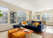 Thumbnail 21 of 28 - a living room with a couch and a coffee table at Residences at Stevens Pond, MA 01906