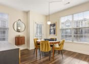 Thumbnail 17 of 28 - a dining room with a table and chairs and a window at Residences at Stevens Pond, Massachusetts