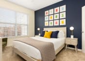 Thumbnail 24 of 28 - a bedroom with a bed and a blue wall and a window at Residences at Stevens Pond, MA 01906