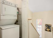 Thumbnail 19 of 28 - a laundry room with a washer and dryer and a window at Residences at Stevens Pond, Massachusetts, 01906