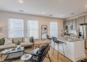 Thumbnail 2 of 39 - a living room with a kitchen and a table at The Merchant Apartments, Charleston