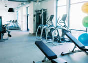 Thumbnail 30 of 39 - a gym with cardio equipment and large windows at The Merchant Apartments, Charleston