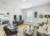 Thumbnail 4 of 39 - living room with a couch and a tv at The Merchant Apartments, Charleston, SC, 29403