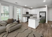 Thumbnail 9 of 39 - a living room with a kitchen and a couch at The Merchant Apartments, Charleston