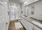 Thumbnail 14 of 39 - a bathroom with two sinks and a shower at The Merchant Apartments, Charleston, South Carolina