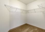 Thumbnail 12 of 28 - an oversized closet with white walls and built in shelving at 128 on State, Kirkland