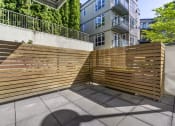 Thumbnail 3 of 28 - a wooden privacy fence in front of an apartment complex  at 128 on State, Washington