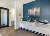 Thumbnail 27 of 28 - resident coffee station with a blue wall and an elegant white cabinet at 128 on State, Washington, 98033
