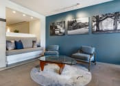 Thumbnail 22 of 28 - a stunning living room with calming blue accent wall and cozy chairs at 128 on State, Kirkland, Washington