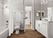 Thumbnail 22 of 40 - a white bathroom with a toilet and a tub at Aston at Cinco Ranch, Katy