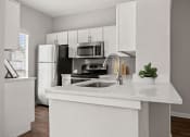Thumbnail 18 of 40 - an empty kitchen with a sink and a refrigerator at Aston at Cinco Ranch, Katy, Texas