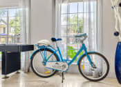 Thumbnail 30 of 40 - a blue bike parked in front of a window at Aston at Cinco Ranch, Katy