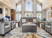 Thumbnail 27 of 40 - a lobby with couches and chairs and a table at Aston at Cinco Ranch, Katy, Texas