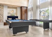 Thumbnail 29 of 40 - two pool tables in a living room with large windows at Aston at Cinco Ranch, Katy, 77450
