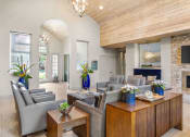 Thumbnail 28 of 40 - a living room with couches and tables and a fireplace at Aston at Cinco Ranch, Texas