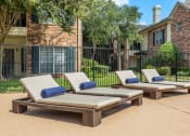 Thumbnail 36 of 40 - pool deck with chaise lounge chairs at Aston at Cinco Ranch, Katy, Texas