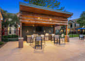 Thumbnail 39 of 40 - a covered patio with a bar and dining area at Aston at Cinco Ranch, Katy, 77450