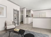Thumbnail 2 of 40 - a living room with a couch and a chair and a kitchen at Aston at Cinco Ranch, Katy