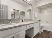 Thumbnail 10 of 40 - a bathroom with a sink and a toilet and a mirror at Aston at Cinco Ranch, Katy, 77450
