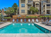 Thumbnail 24 of 32 - our apartments have a swimming pool with chairs and umbrellas at Arcadia Apartments, Colorado