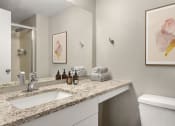 Thumbnail 15 of 32 - a bathroom with a sink and a mirror and a toilet at Arcadia Apartments, Colorado