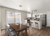 Thumbnail 11 of 32 - a kitchen and dining room with a table and chairs at Arcadia Apartments, Centennial, Colorado