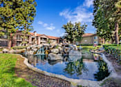 Thumbnail 48 of 50 - a fountain in the middle of pond surrounded  a grassy area with buildings in the background  at Citrine Hills, Ontario, CA, 91761