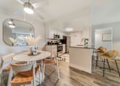 Thumbnail 1 of 50 - a dining area with a table and chairs and a kitchen in the background  at Citrine Hills, Ontario, CA, 91761
