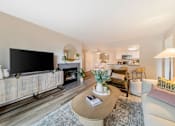 Thumbnail 3 of 50 - a living room with a large tv and a fireplace  at Citrine Hills, Ontario