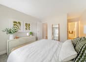 Thumbnail 6 of 50 - a bedroom with a large bed and a dresser with a plant on it  at Citrine Hills, California, 91761