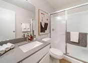 Thumbnail 7 of 50 - a bathroom with a white sink and toilet next to a shower with a glass door  at Citrine Hills, Ontario, 91761