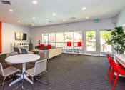 Thumbnail 9 of 17 - a lounge area with chairs and tables and windows at Skyview Apartments, Westminster, CO