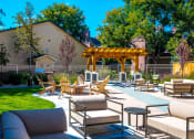 Thumbnail 14 of 17 - a patio with chairs and tables and a gazebo at Skyview Apartments, Westminster Colorado