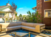 Thumbnail 15 of 17 - the patio of a house with a couch and tables at Skyview Apartments, Westminster