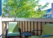 Thumbnail 8 of 17 - a patio with two chairs and a table on a balcony at Skyview Apartments, Colorado, 80234