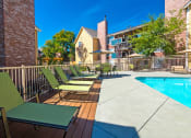 Thumbnail 16 of 17 - our apartments have a large pool and a deck with chairs at Skyview Apartments, Westminster, CO