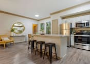 Thumbnail 1 of 30 - a kitchen with a large island with three stools at Summerwind, Pearland, 77584