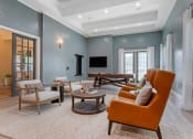 Thumbnail 13 of 30 - a living room with blue walls and an orange couch at Summerwind, Texas, 77584