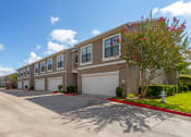 Thumbnail 29 of 30 - a building with two garages and a street in front of it at Summerwind, Texas