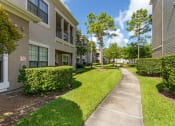 Thumbnail 28 of 30 - walkway between two apartment buildings at Summerwind, Pearland Texas
