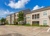 Thumbnail 30 of 30 - an empty parking lot in front of an apartment building at Summerwind, Pearland, TX