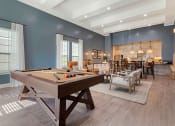 Thumbnail 14 of 30 - a pool table in a living room with a bar and a dining room at Summerwind, Pearland, 77584