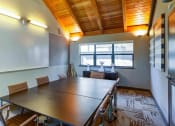 Thumbnail 21 of 25 - a meeting room with a long table and chairs at The Lakes Apartments, Bellevue, 98007