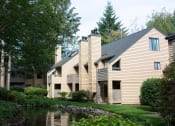 Thumbnail 24 of 25 - a large building with a pond in front of it at The Lakes Apartments, Washington, 98007